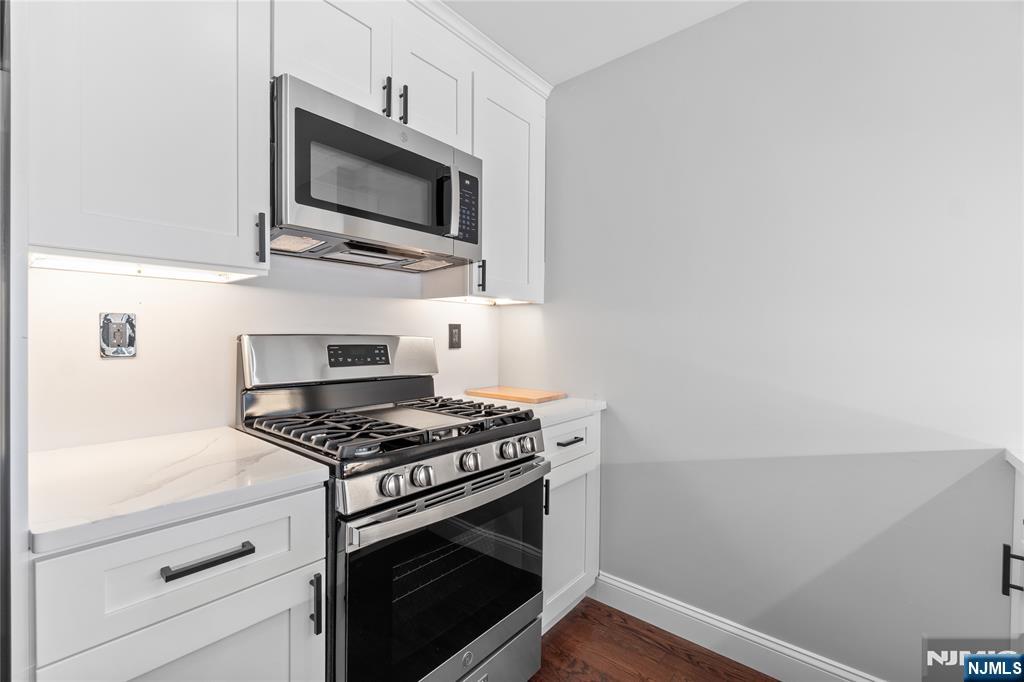 481 15th Avenue Newark, NJ 07103 - Photo 8 of 19 a kitchen with stainless steel appliances a white stove top oven and sink
