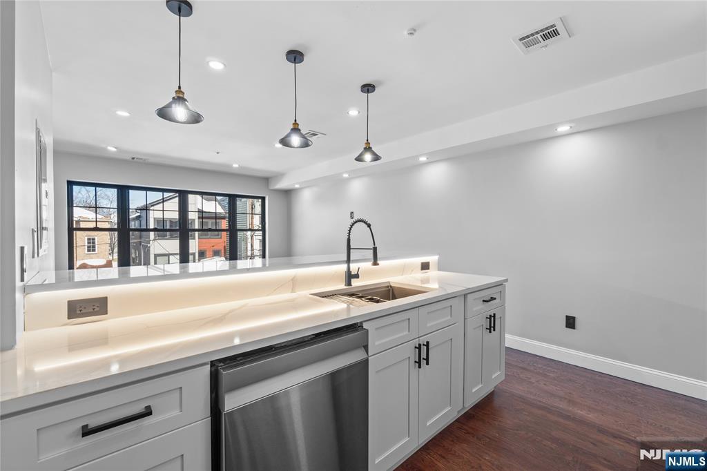 481 15th Avenue Newark, NJ 07103 - Photo 9 of 19 a kitchen with a sink and chandelier