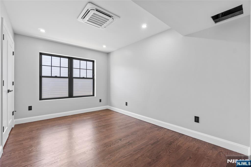 481 15th Avenue Newark, NJ 07103 - Photo 10 of 19 wooden floor in an empty room with a window