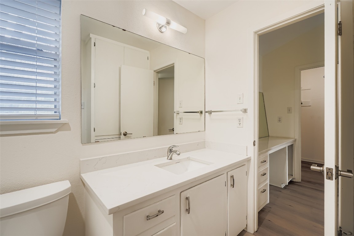 2000 Cody Court, Unit A Austin, TX 78704 - Photo 16 of 36 a spacious bathroom with a sink a toilet a shower and a mirror