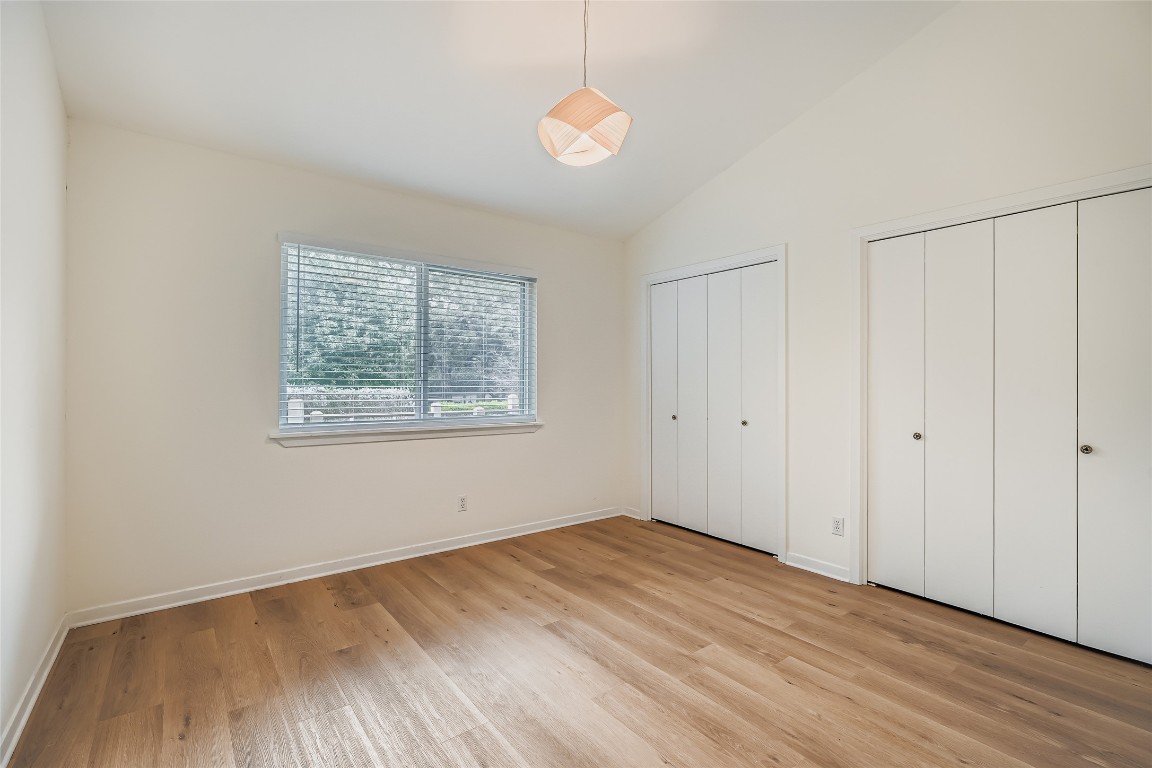 2000 Cody Court, Unit A Austin, TX 78704 - Photo 18 of 36 an empty room with wooden floor and windows