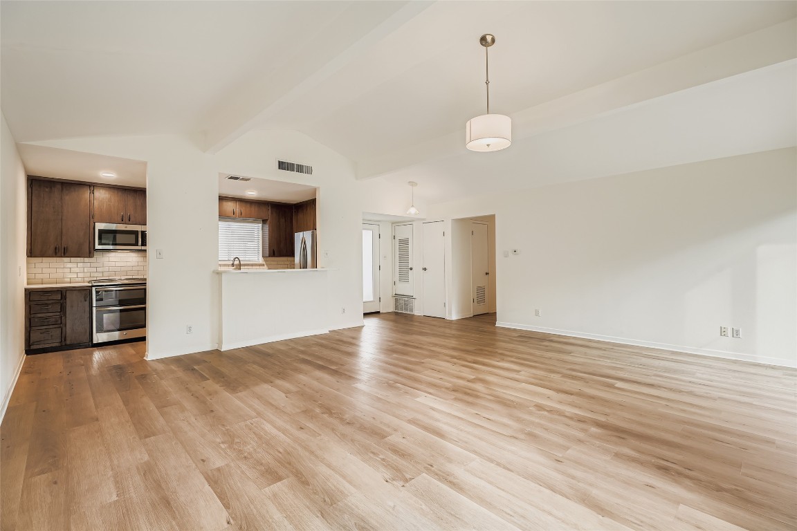 2000 Cody Court, Unit A Austin, TX 78704 - Photo 6 of 36 a view of a kitchen with a stove cabinets and wooden floor