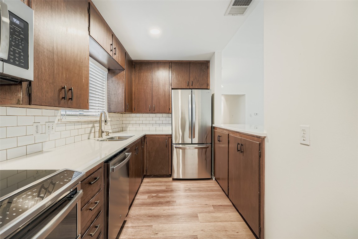 2000 Cody Court, Unit A Austin, TX 78704 - Photo 9 of 36 a kitchen with stainless steel appliances a sink and a refrigerator