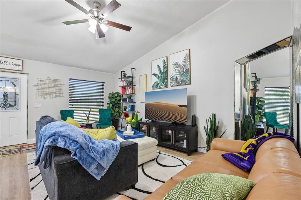 1525 Kestrel Way Brandon, FL 33511 - Photo 15 of 48 a living room with furniture a flat screen tv and a window