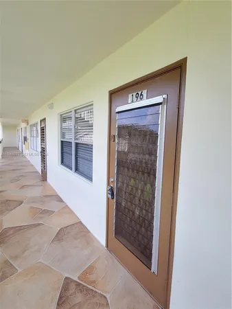 a view of hallway with cabinets and wooden floor