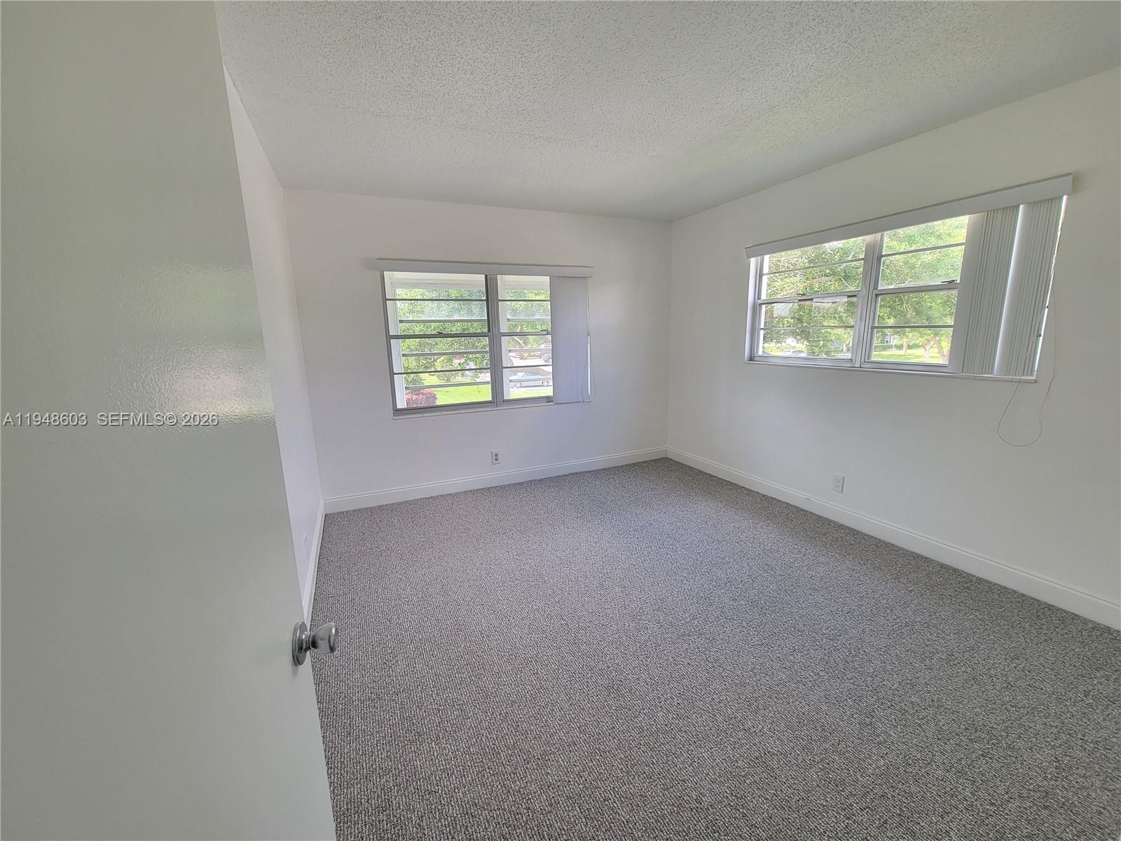 196 Mansfield F, Unit 196 Boca Raton, FL 33434 - Photo 18 of 58 an empty room with a window