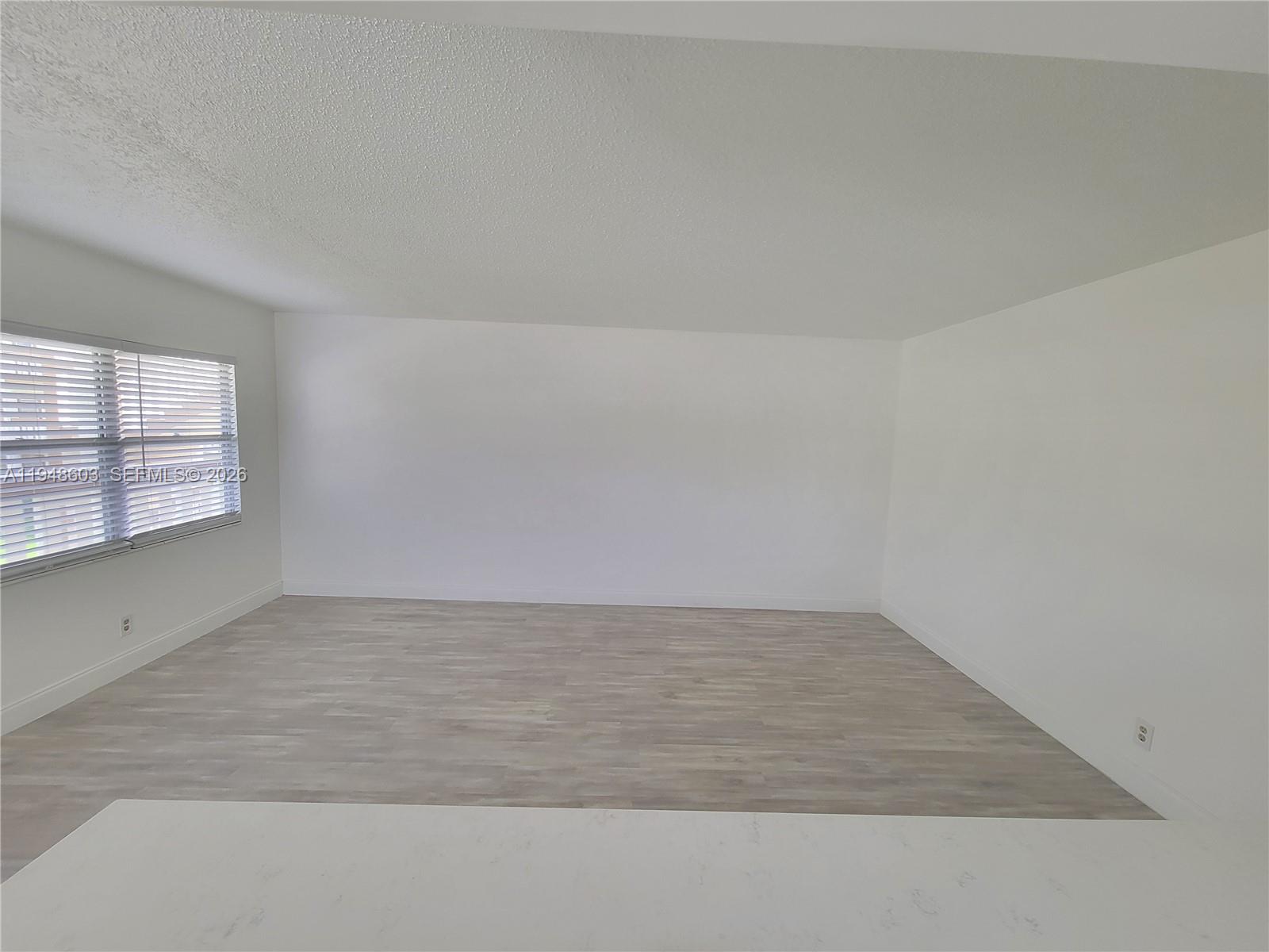 196 Mansfield F, Unit 196 Boca Raton, FL 33434 - Photo 23 of 58 an empty room with windows