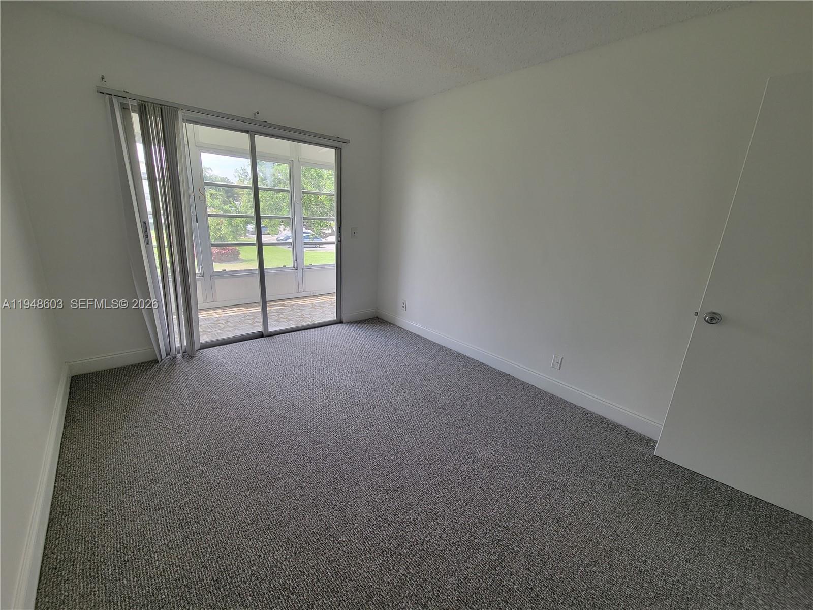 196 Mansfield F, Unit 196 Boca Raton, FL 33434 - Photo 24 of 58 a view of an empty room and a window