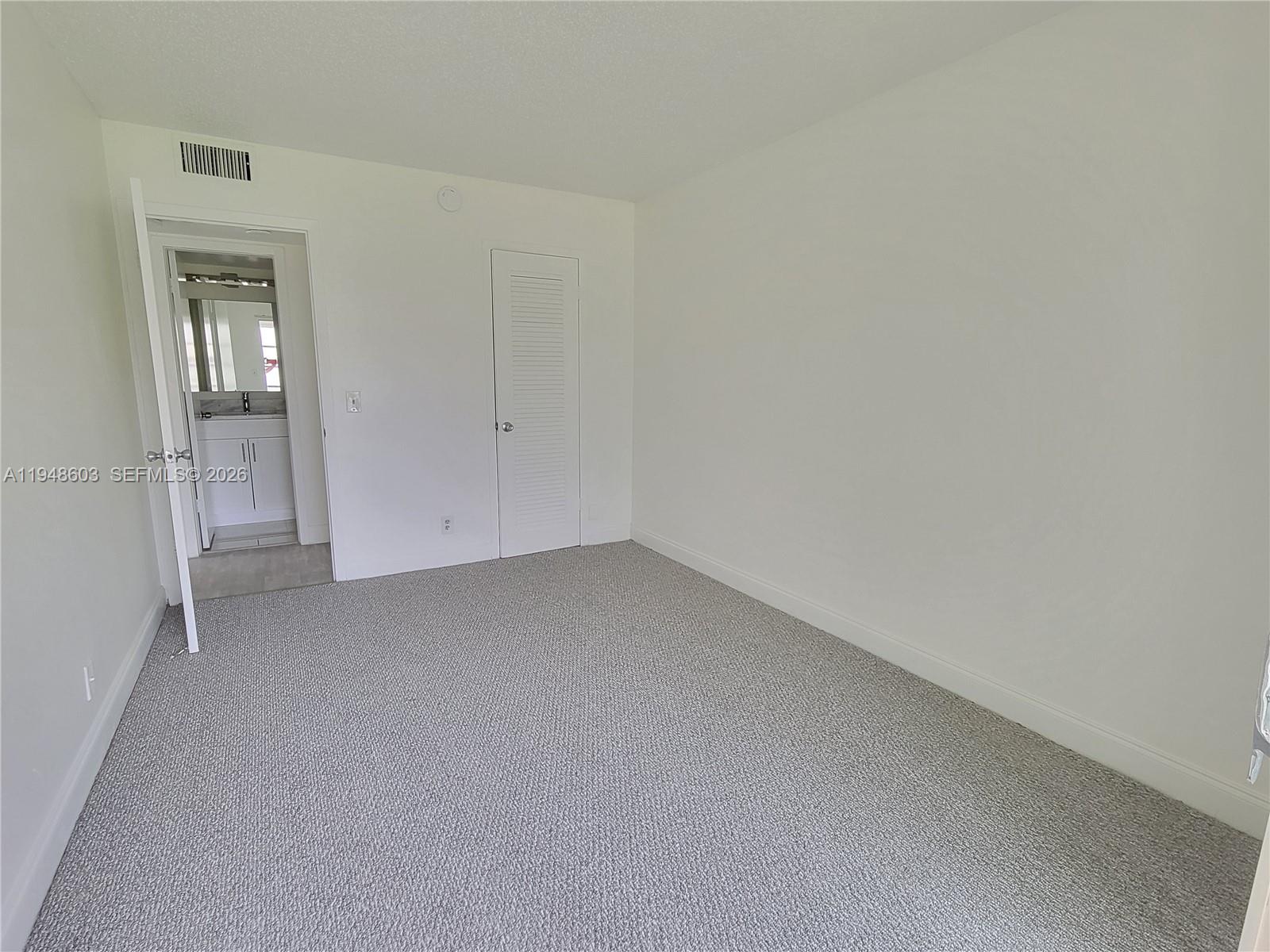 196 Mansfield F, Unit 196 Boca Raton, FL 33434 - Photo 26 of 58 a view of empty room