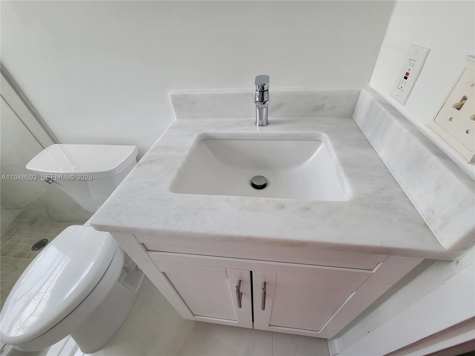 196 Mansfield F, Unit 196 Boca Raton, FL 33434 - Photo 32 of 58 a bathroom with a sink and toilet