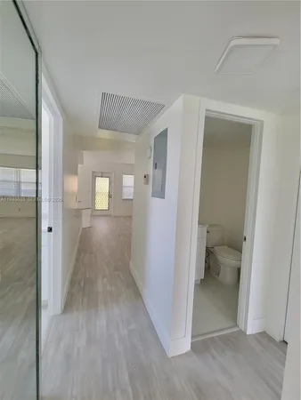 a living room with furniture a dining table and a chandelier