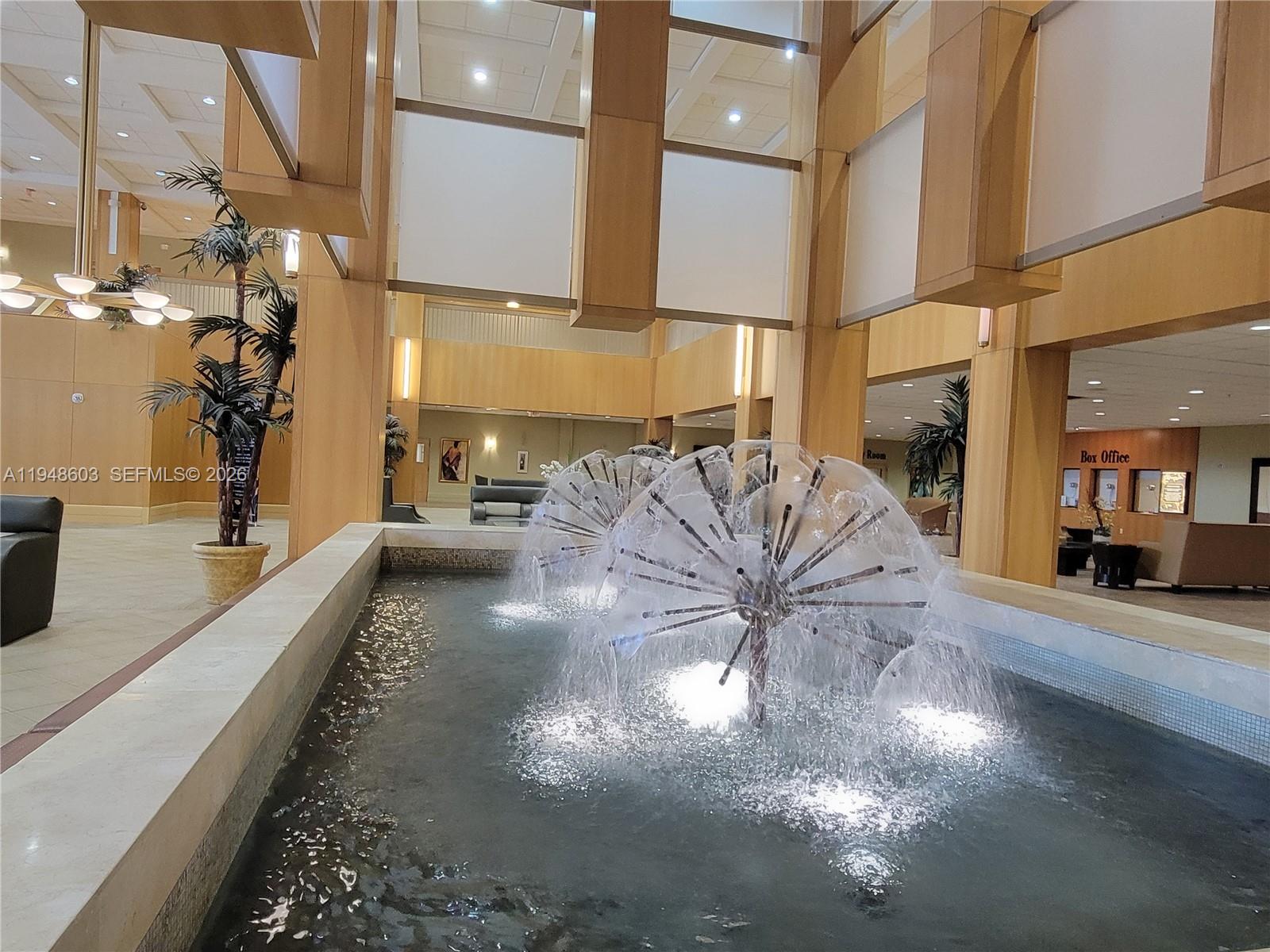 196 Mansfield F, Unit 196 Boca Raton, FL 33434 - Photo 43 of 58 a view of a living room and chandelier