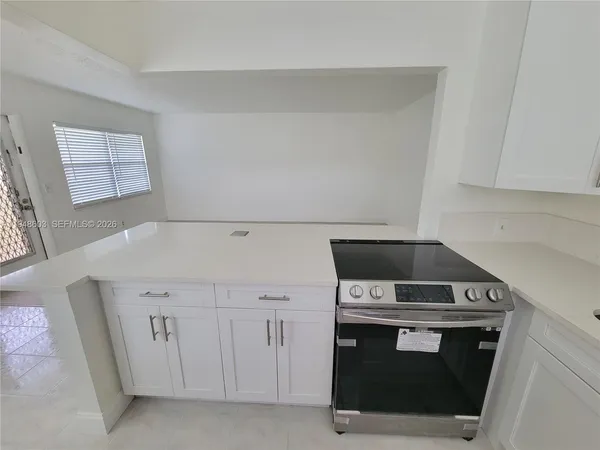 a view of a kitchen cabinets and a window
