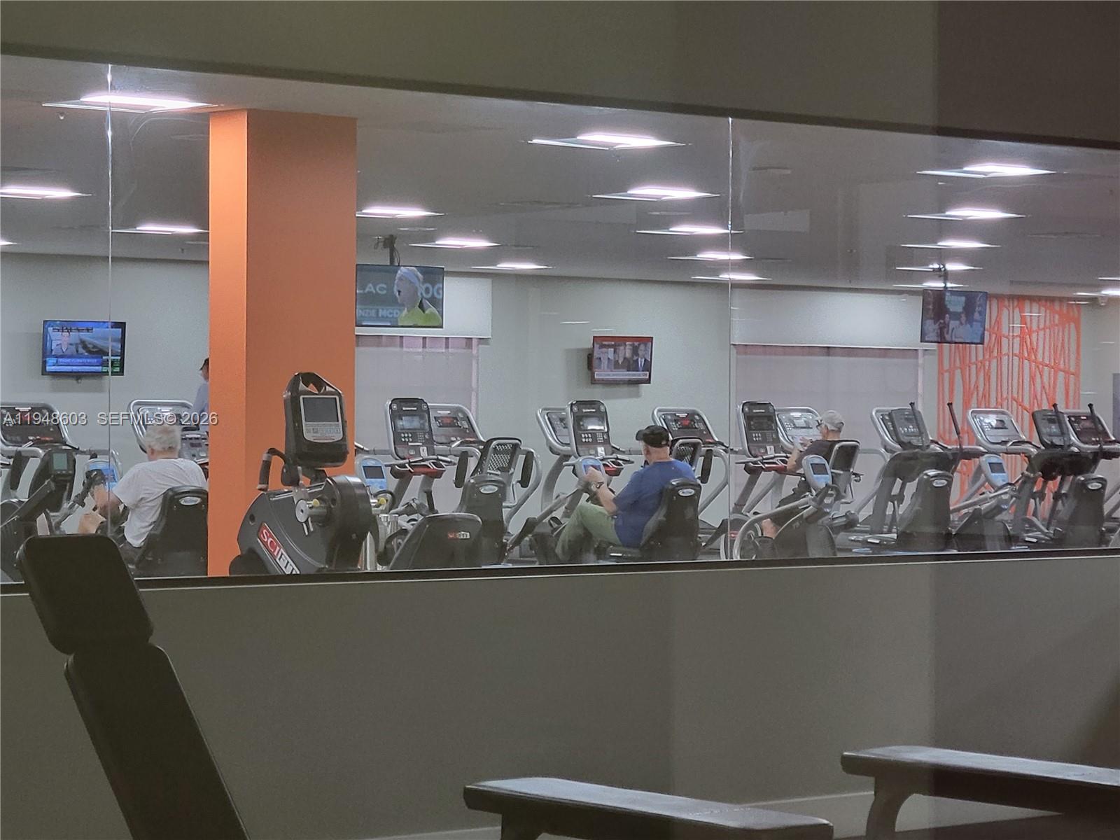 196 Mansfield F, Unit 196 Boca Raton, FL 33434 - Photo 51 of 58 a view of a room with gym equipment