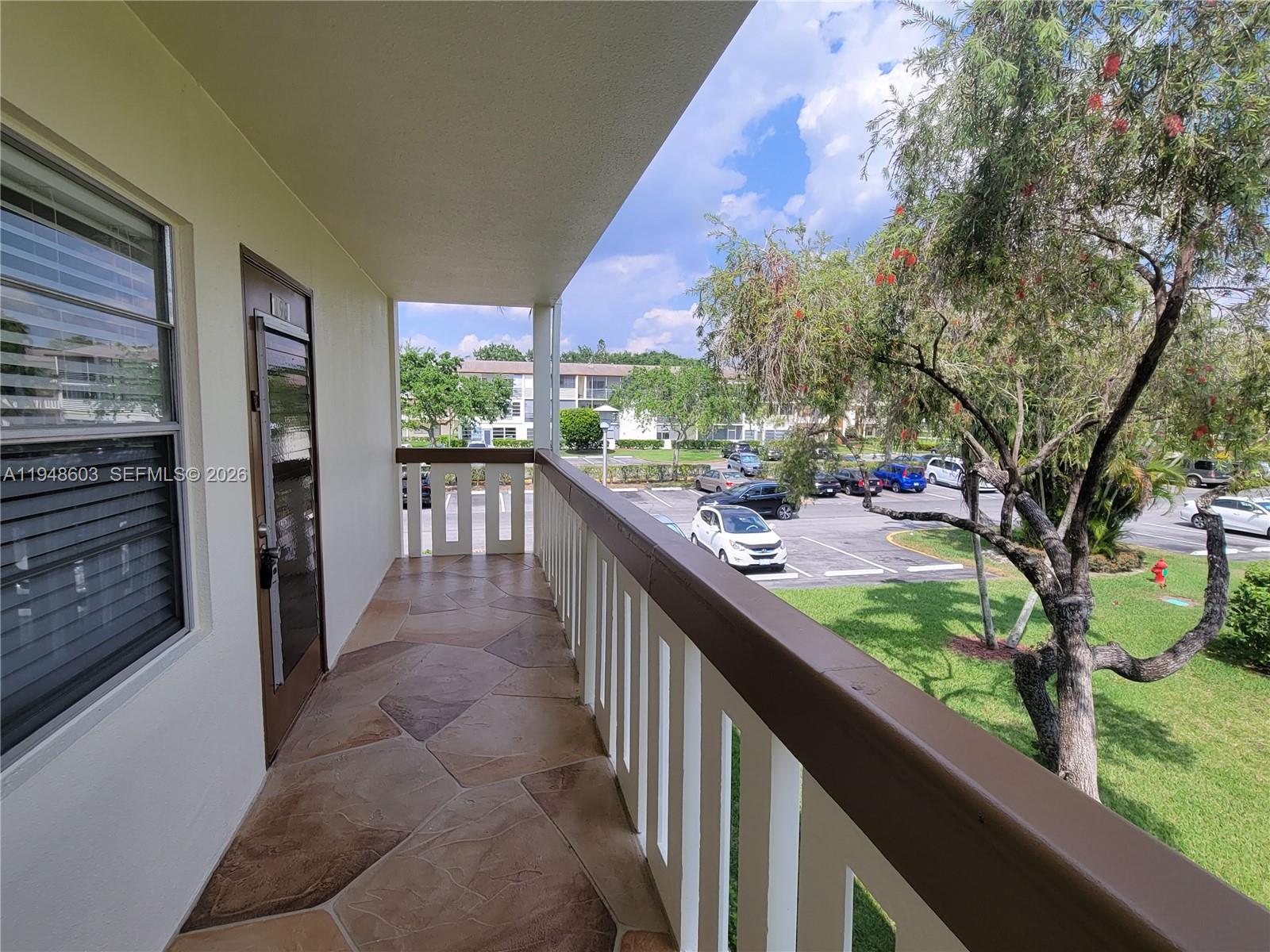 196 Mansfield F, Unit 196 Boca Raton, FL 33434 - Photo 6 of 58 a view of a porch and garden