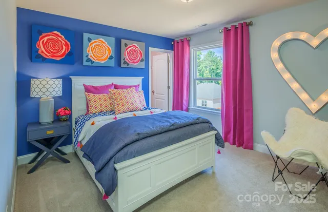 a bed room with a bed and a chair