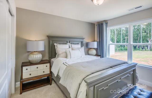 a bedroom with a bed and large window