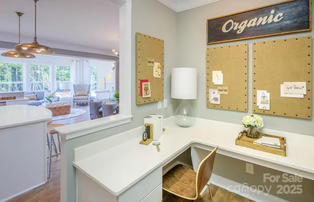 a kitchen with a sink a counter top space and living room view