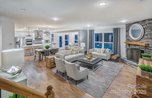 a living room with fireplace furniture and a large window