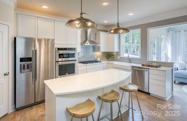 a kitchen with cabinets a counter space appliances and windows