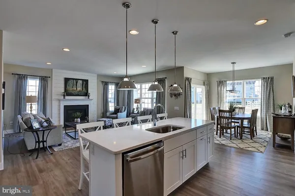 a view of living room kitchen island dining table and chairs