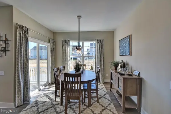 a dining room with furniture a chandelier and window