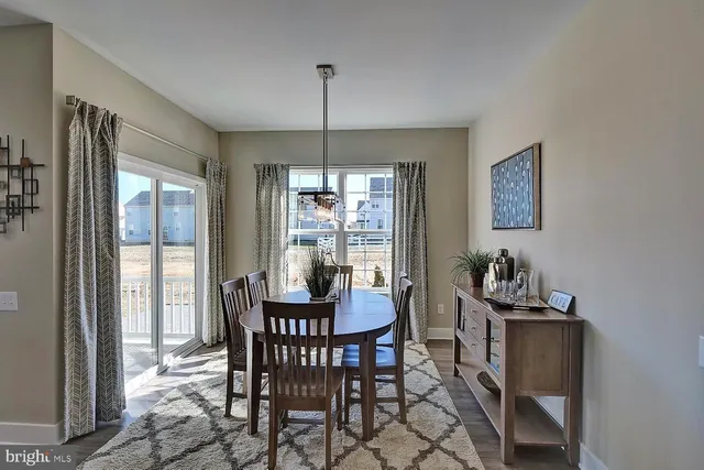 a dining room with furniture a chandelier and window