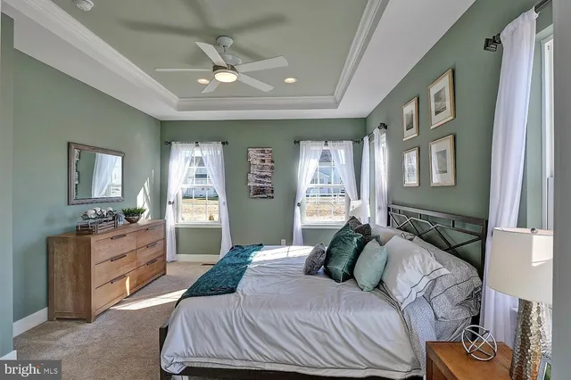 a bedroom with a bed and dresser with mirror