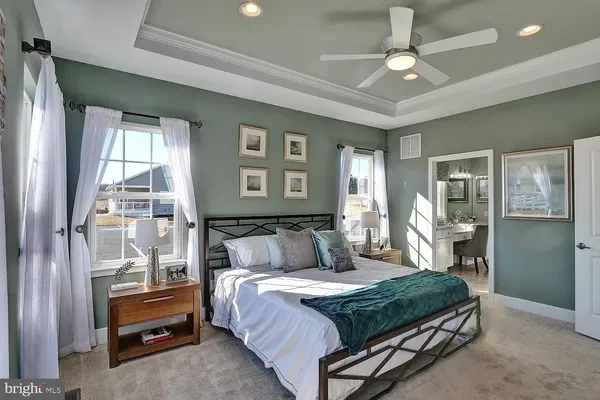 a bedroom with a large bed and a chandelier