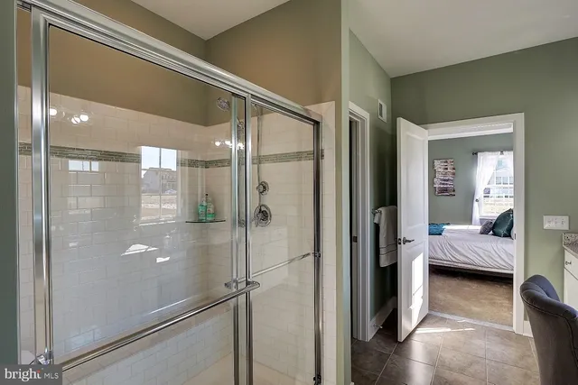 a bathroom with a glass shower door and a glass door