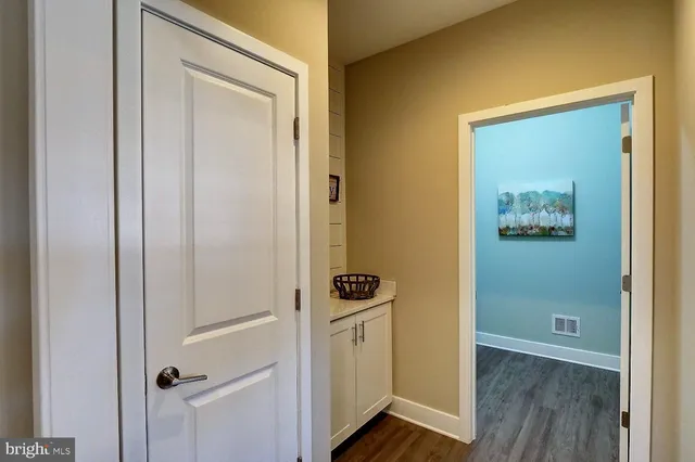 a view of a hallway with wooden floor