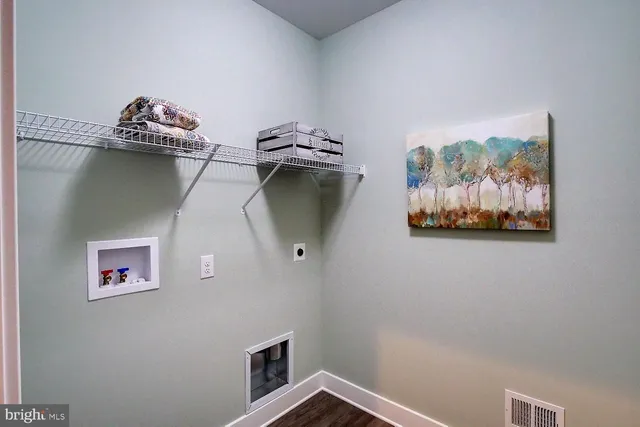 a living room with furniture and a lamp