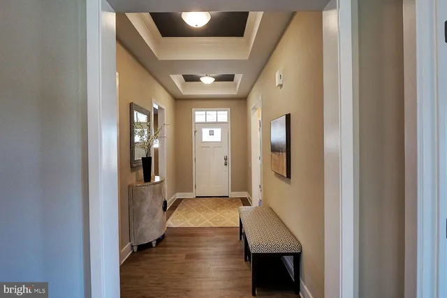 a hallway with wooden floor windows and livingroom