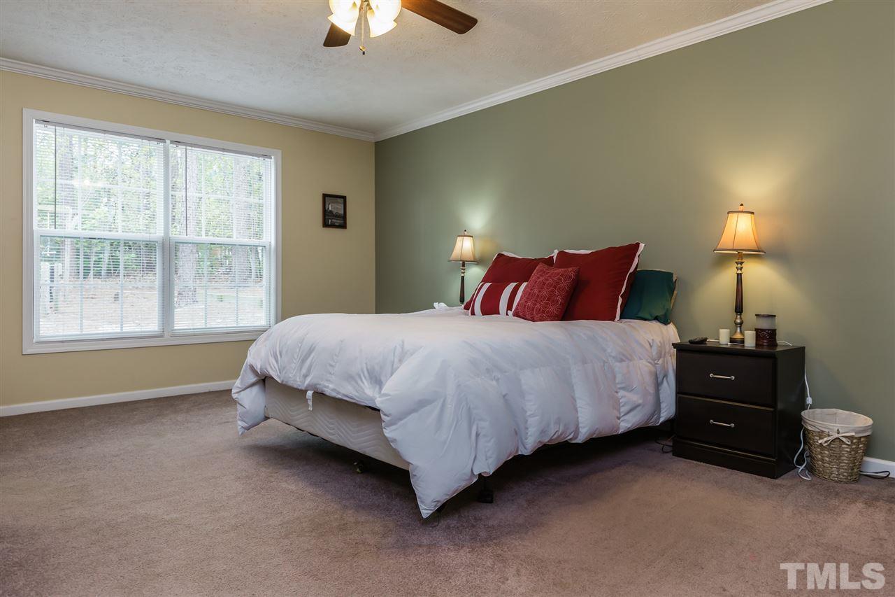 707 Sun Road Aberdeen, NC 28315 - Photo 11 of 23 a bedroom with a bed lamp and window