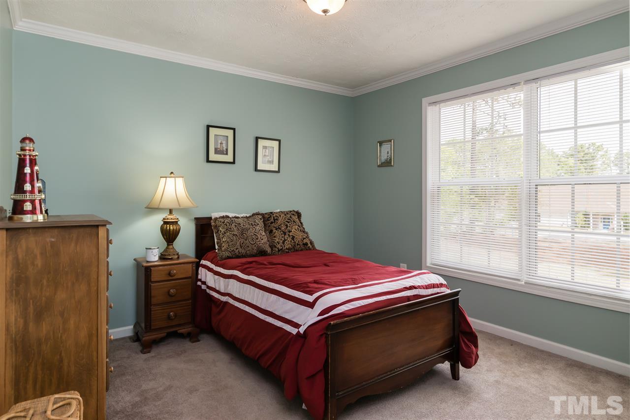 707 Sun Road Aberdeen, NC 28315 - Photo 13 of 23 a bed sitting in a bedroom next to a window