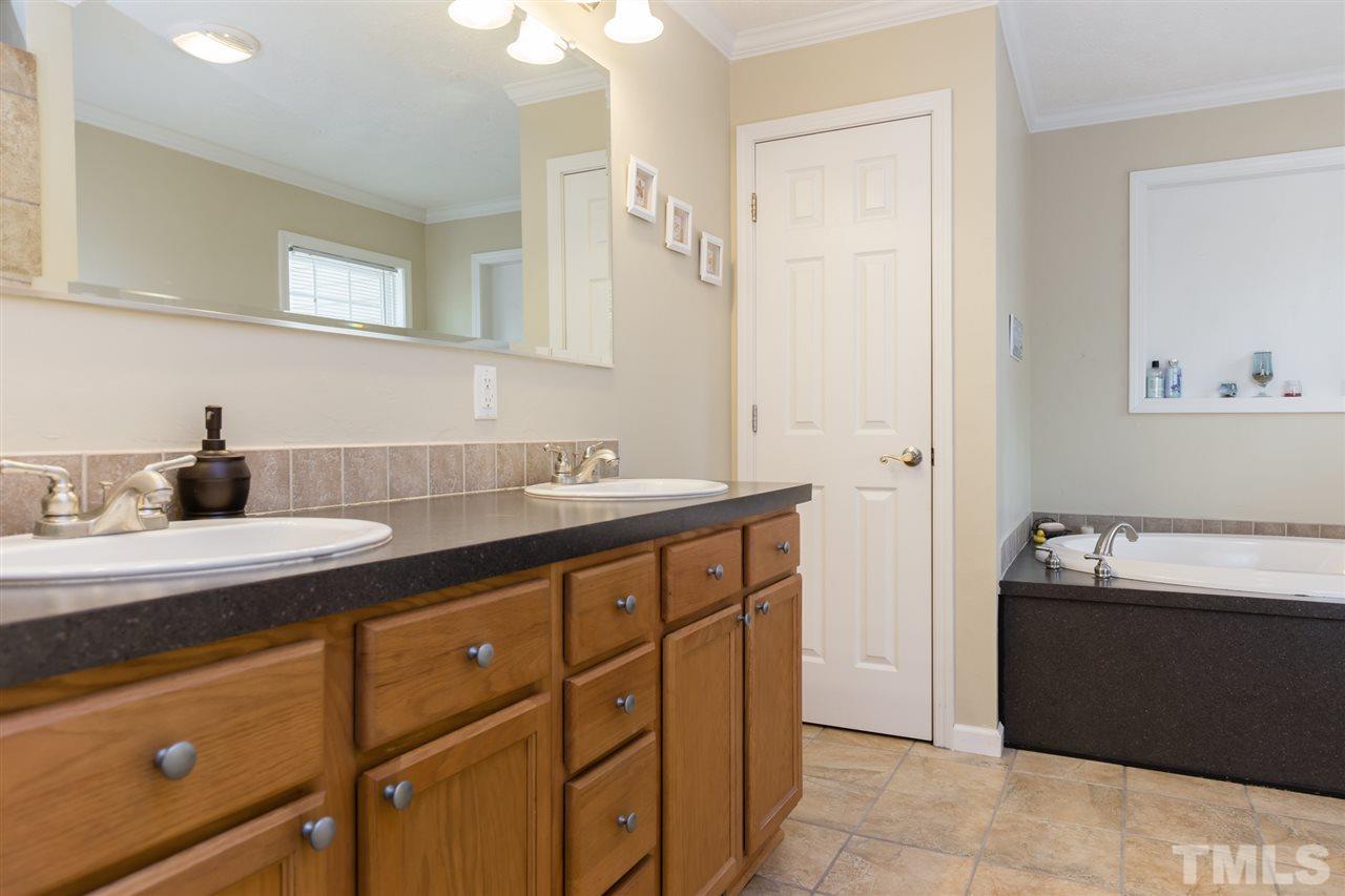 707 Sun Road Aberdeen, NC 28315 - Photo 14 of 23 a spacious bathroom with a sink and mirror