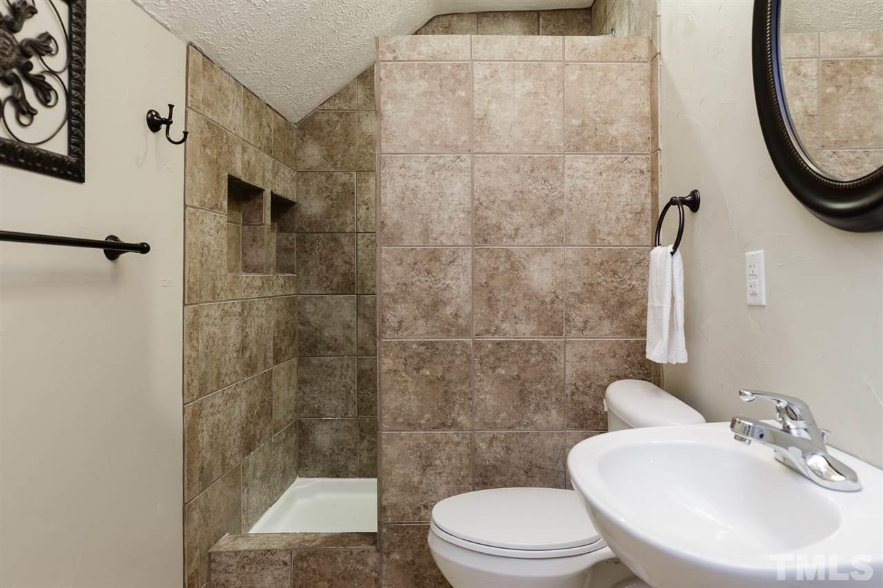 707 Sun Road Aberdeen, NC 28315 - Photo 21 of 23 a bathroom with a toilet a sink and a mirror