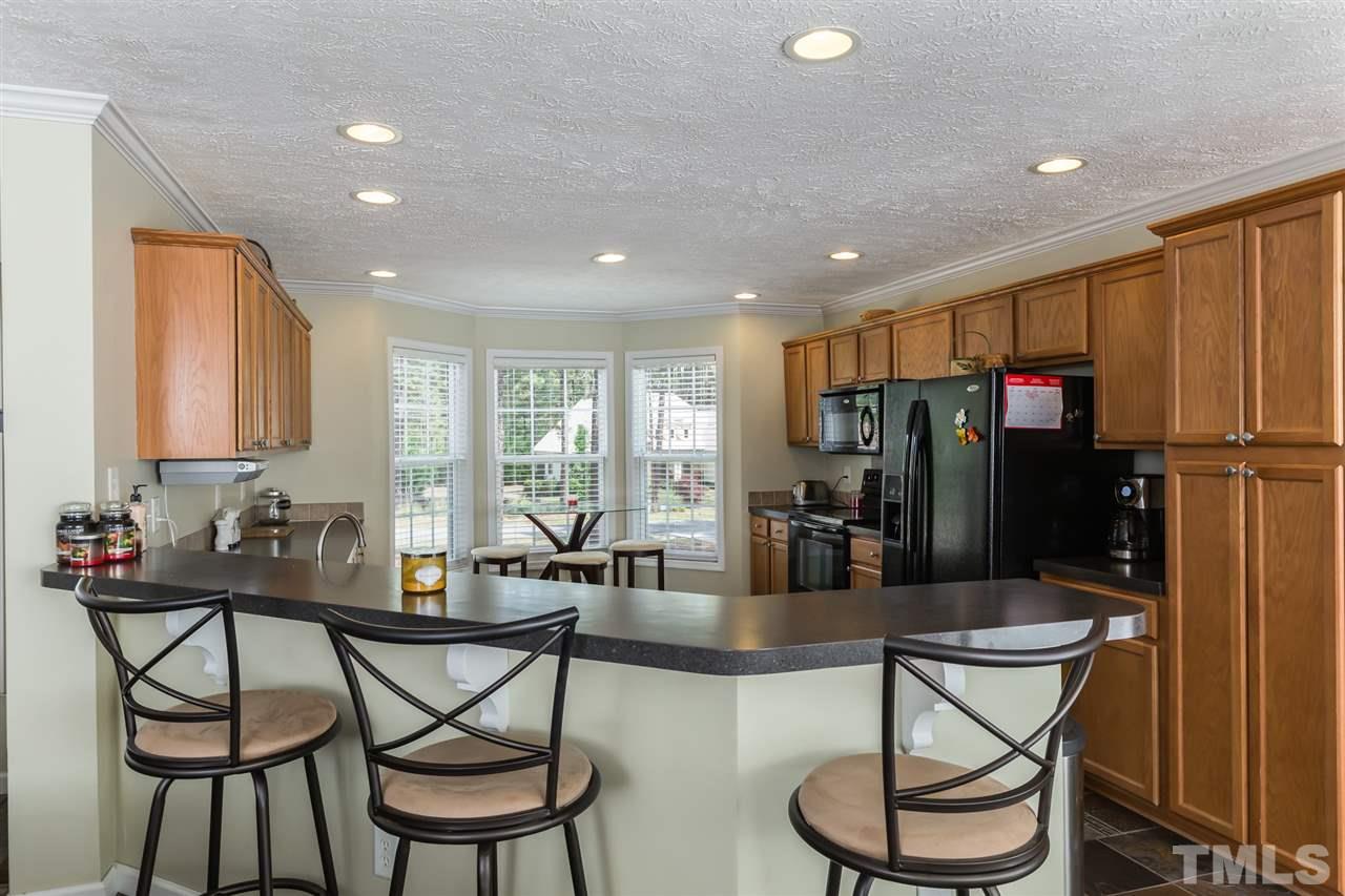 707 Sun Road Aberdeen, NC 28315 - Photo 5 of 23 a kitchen with a dining table and chairs