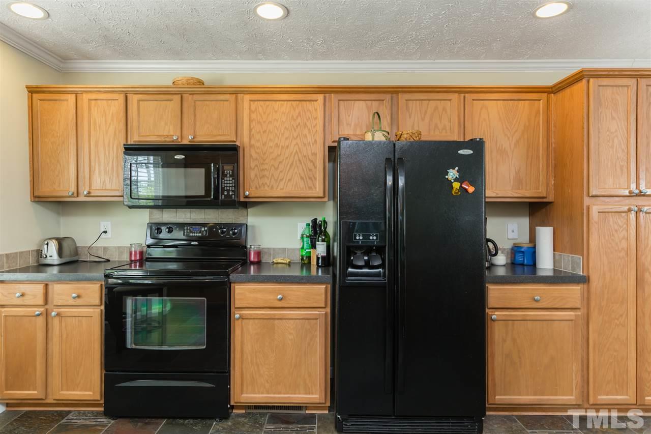 707 Sun Road Aberdeen, NC 28315 - Photo 6 of 23 a kitchen with granite countertop a refrigerator stove and microwave