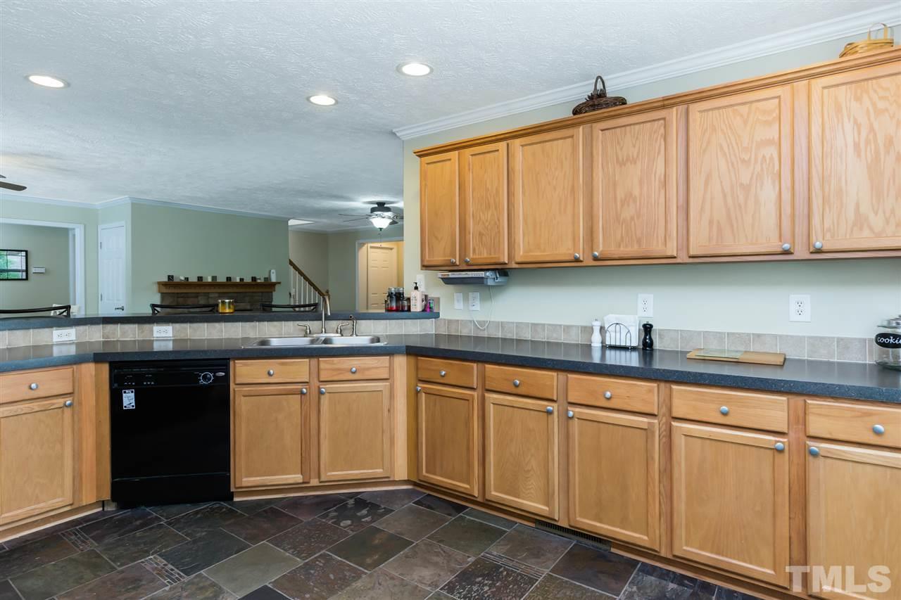 707 Sun Road Aberdeen, NC 28315 - Photo 7 of 23 a kitchen with granite countertop a sink and cabinets