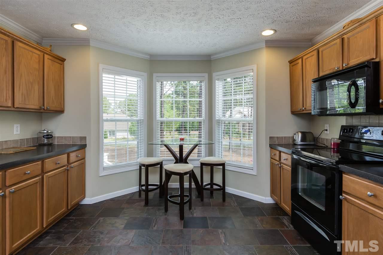 707 Sun Road Aberdeen, NC 28315 - Photo 8 of 23 a kitchen with a stove top oven sink and cabinets