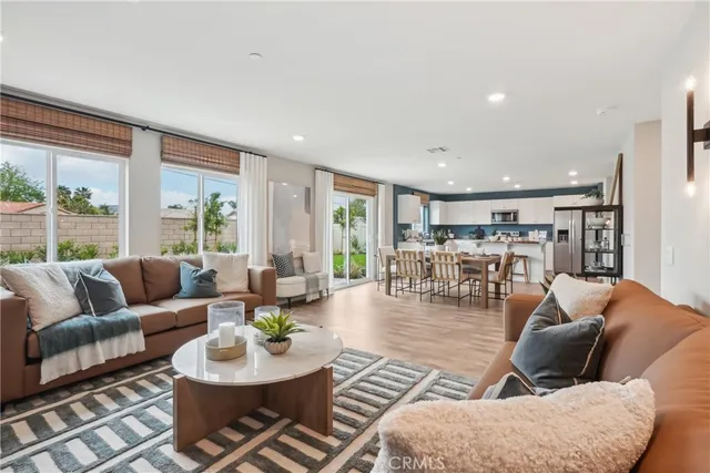 a living room with furniture dining table and a large window