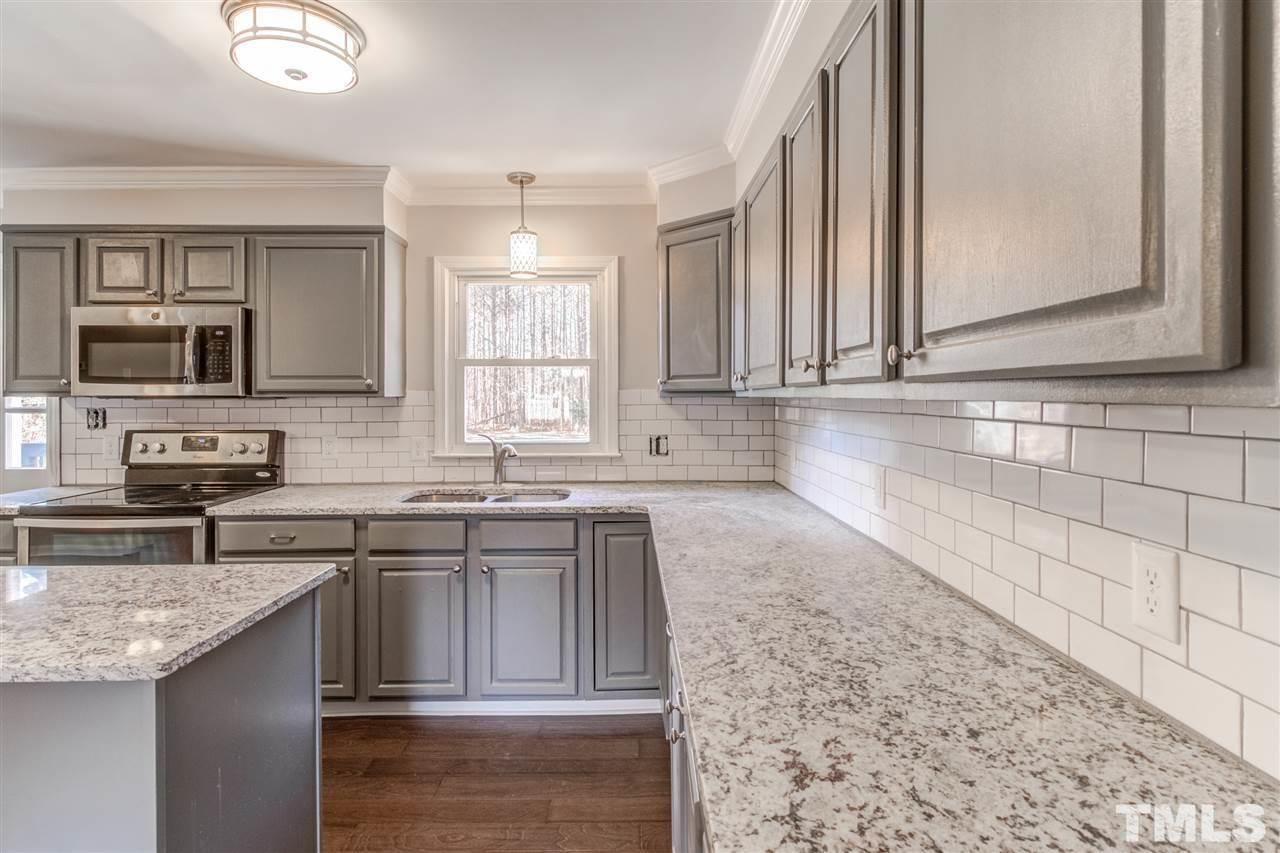 3317 Broughton Road Wendell, NC 27591 - Photo 3 of 11 a kitchen with stainless steel appliances granite countertop a sink stove and microwave