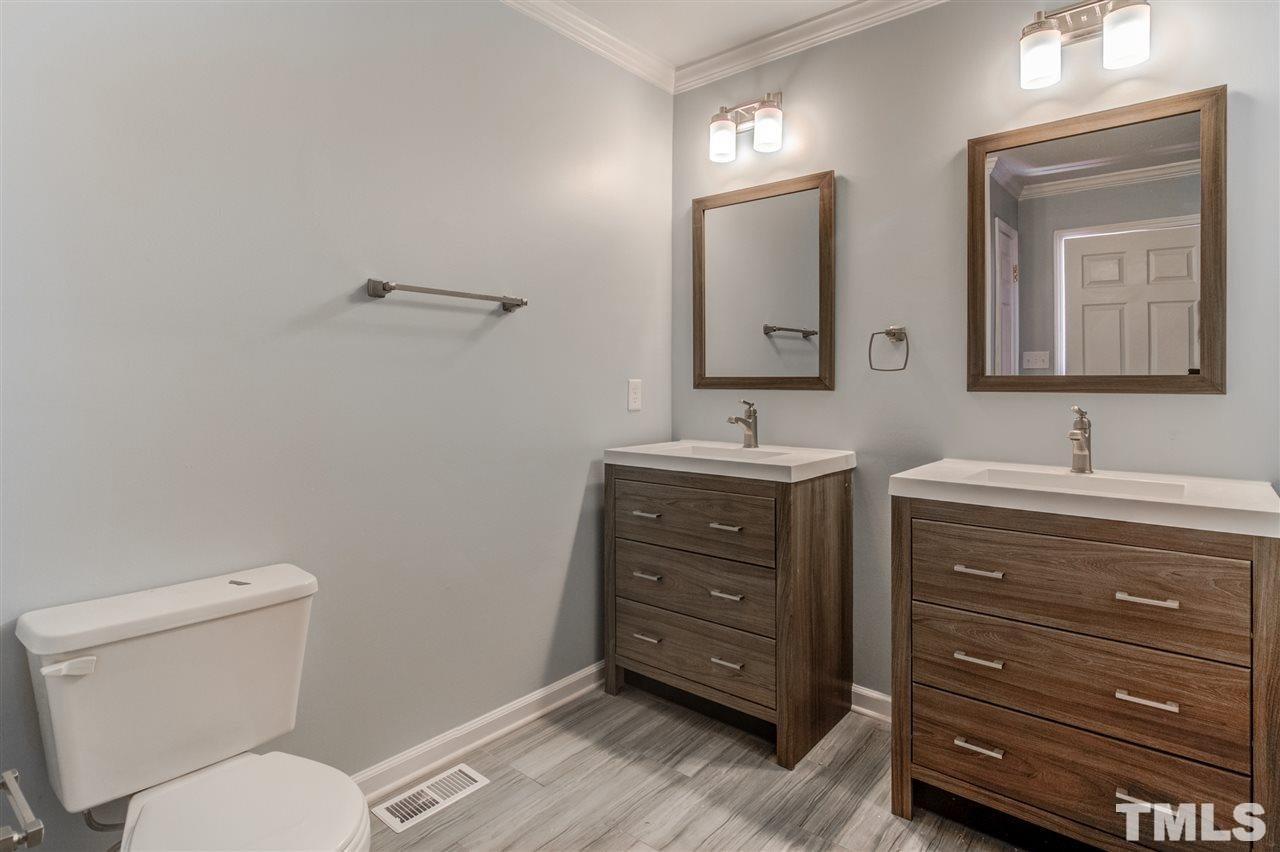 3317 Broughton Road Wendell, NC 27591 - Photo 8 of 11 a bathroom with a toilet a sink and mirror