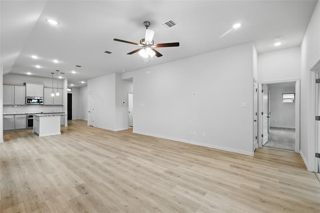949 Schuberts Road Justin, TX 76247 - Photo 11 of 24 Unfurnished living room featuring recessed lighting, ceiling fan, light wood finished floors, and vaulted ceiling