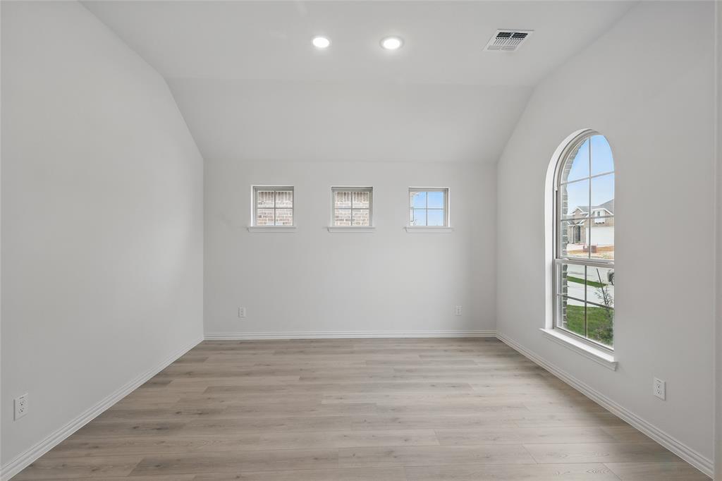 949 Schuberts Road Justin, TX 76247 - Photo 12 of 24 Unfurnished room featuring vaulted ceiling, light wood-style floors, and recessed lighting