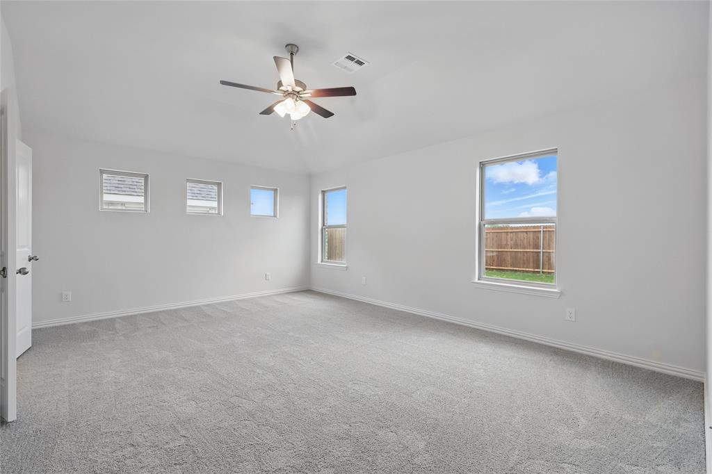 949 Schuberts Road Justin, TX 76247 - Photo 15 of 24 Empty room with light carpet, ceiling fan, and lofted ceiling