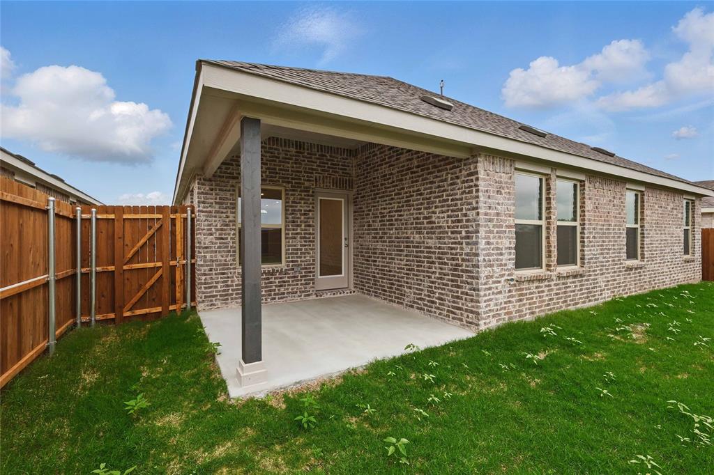 949 Schuberts Road Justin, TX 76247 - Photo 23 of 24 Rear view of property with a patio area, brick siding, and a fenced backyard
