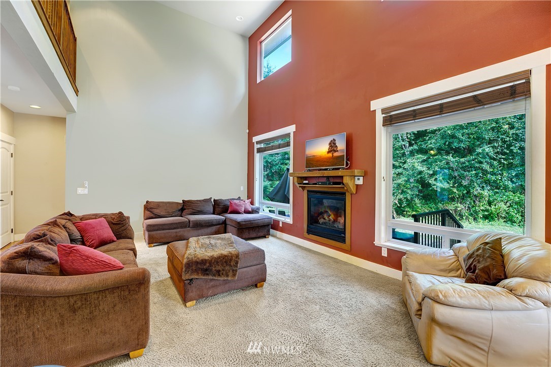1290 West Axton Road Ferndale, WA 98248 - Photo 11 of 36 a living room with furniture fireplace and a large window