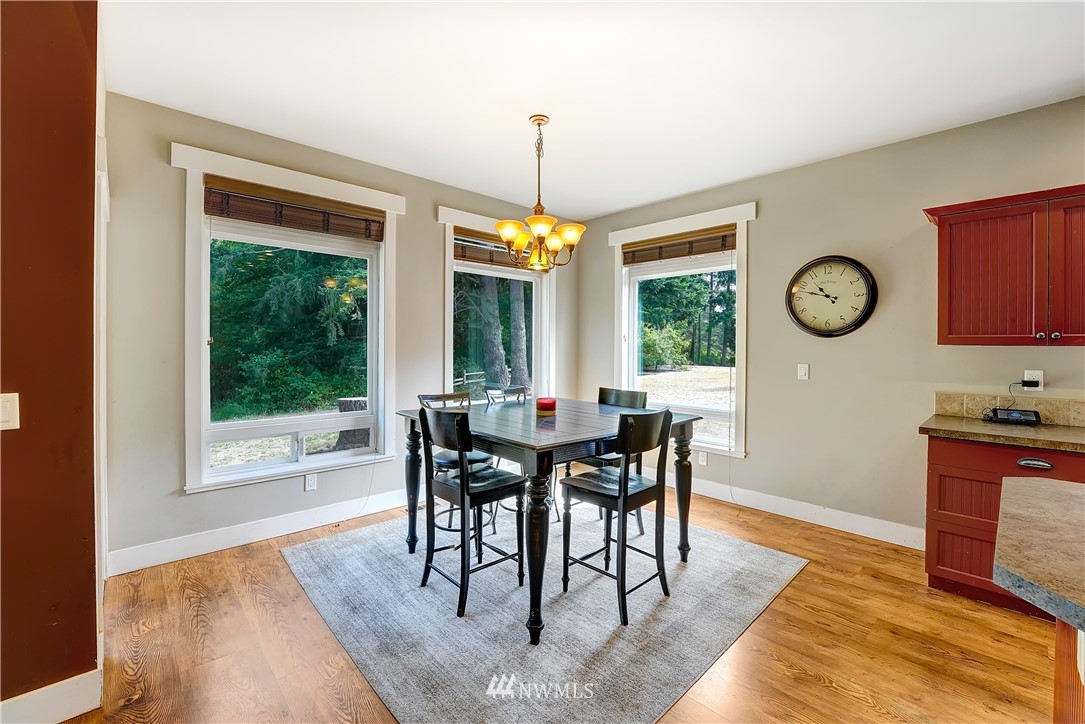 1290 West Axton Road Ferndale, WA 98248 - Photo 12 of 36 a view of a dining room with furniture window and wooden floor